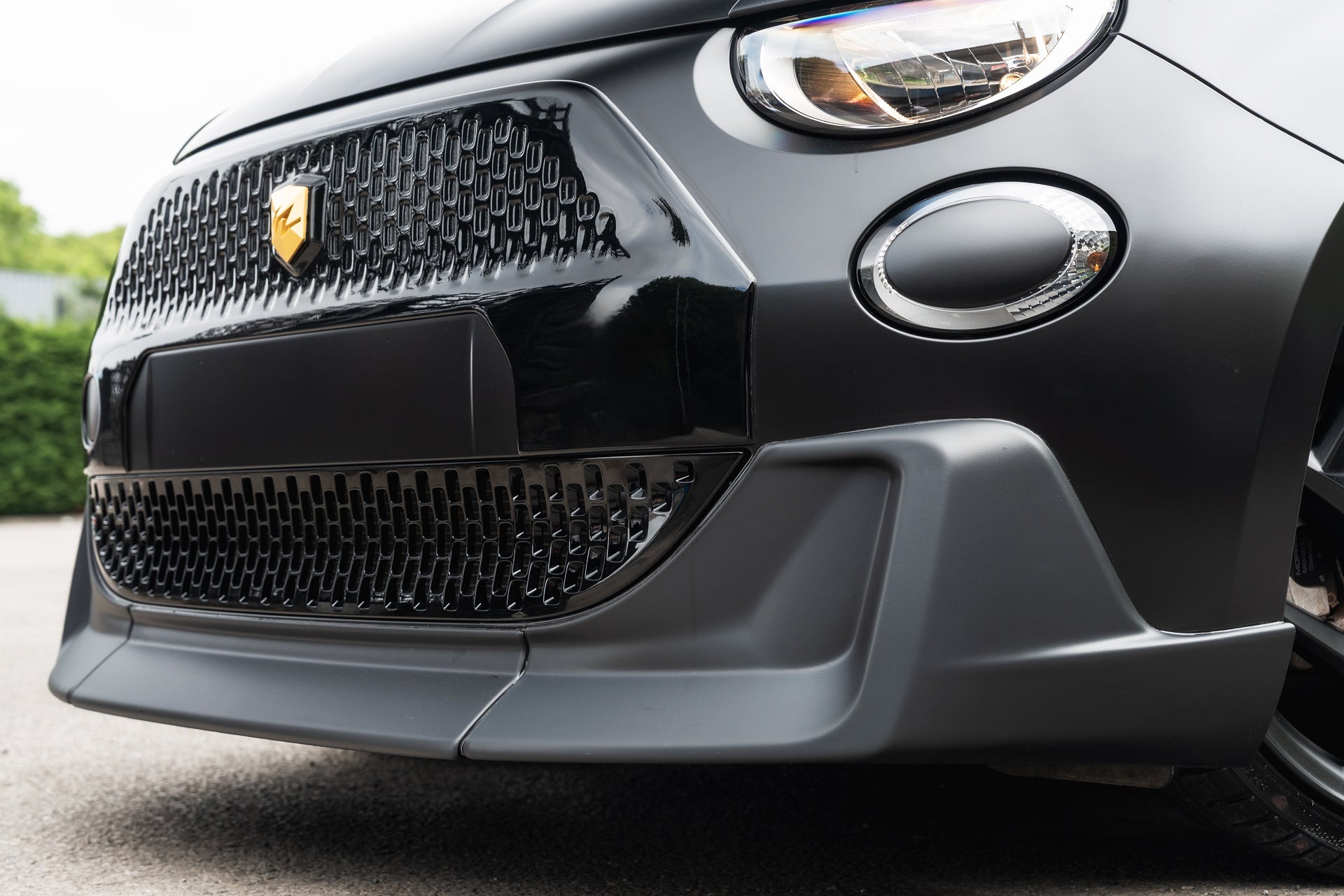 Designio front bumper valance — close-up detail of the Fiat 500e