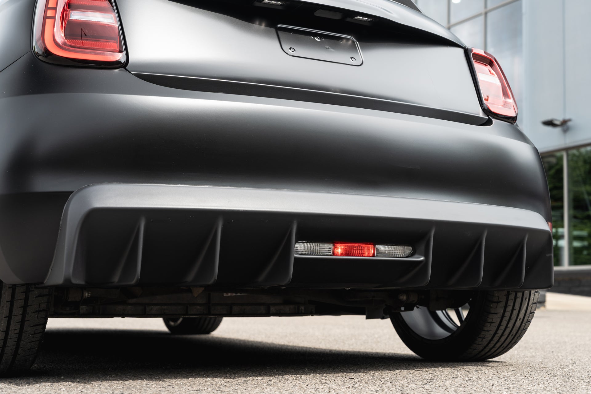 Designio rear bumper valance — close-up detail of the Fiat 500e
