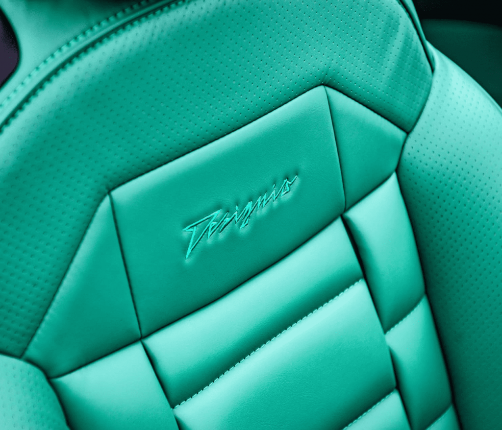 Teal perforated leather seat with Designio embroidery