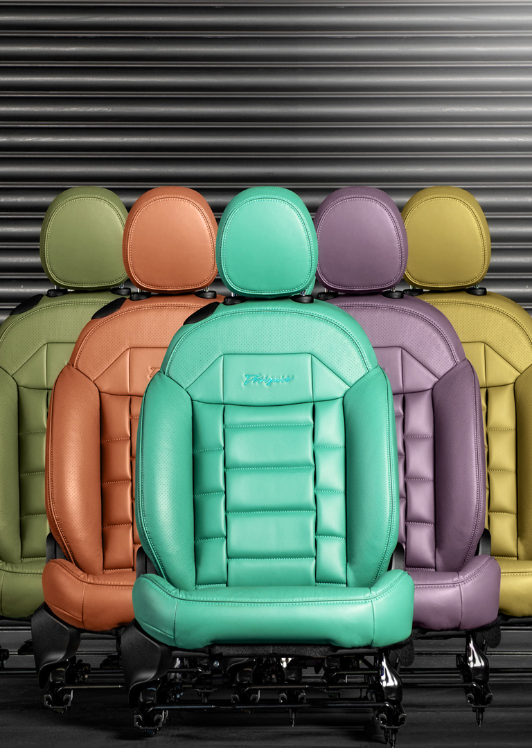 Designio Fiat 500e interior — quilted eco-leather seats in teal with contrast stitching